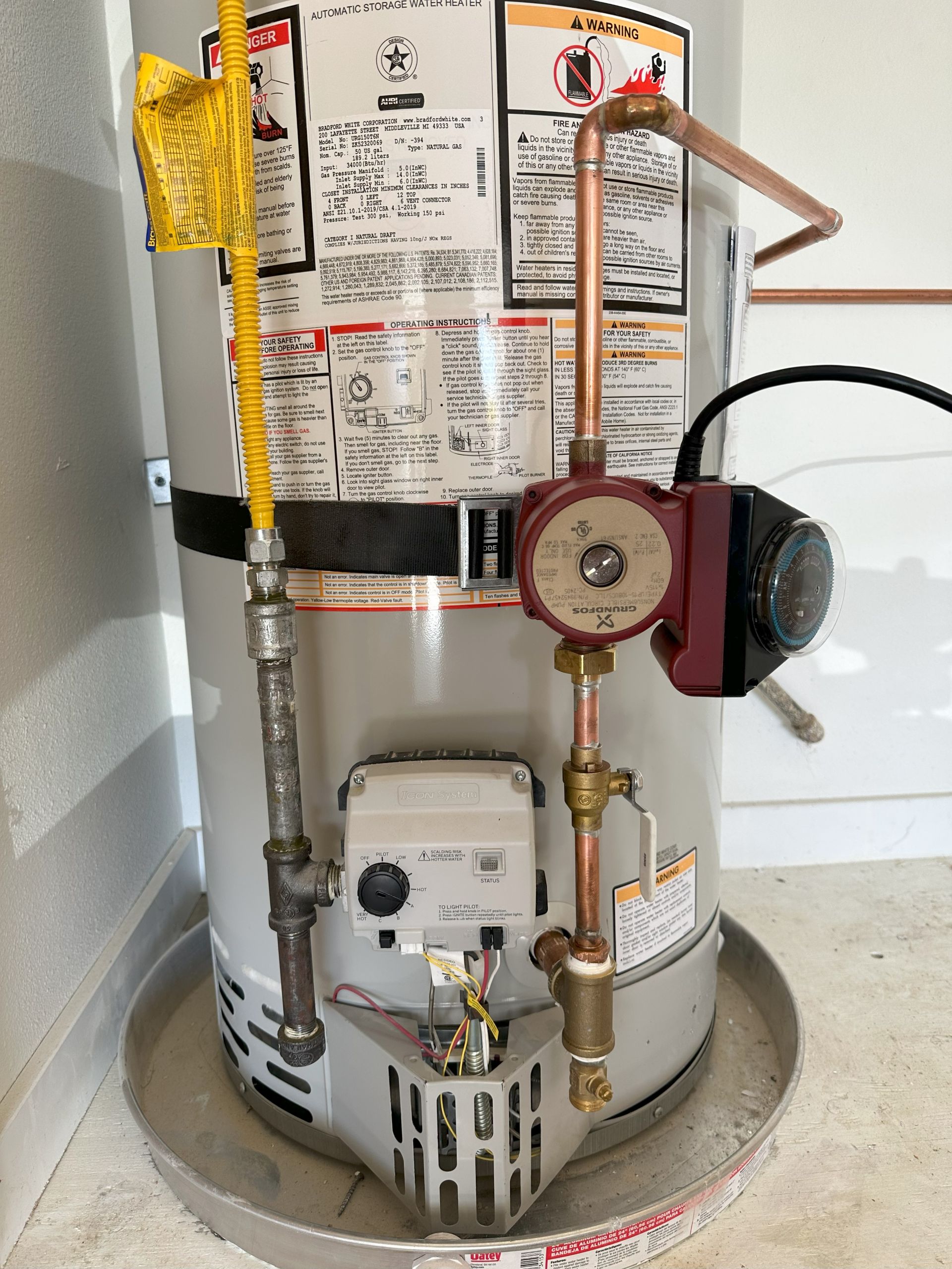 Traditional tank-type water heater installation with recirculation pump in Encinitas, CA